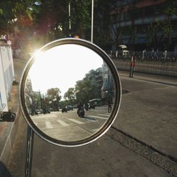 Reflection of man on side-view mirror