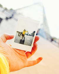 Close-up of person holding camera