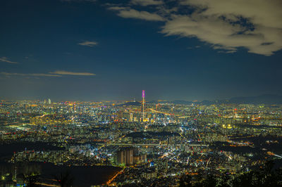 High angle view of city lit up at night