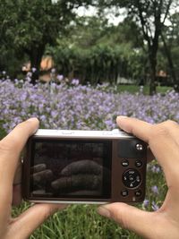 Midsection of woman photographing at camera