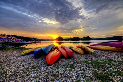 Multi colored boats in lake during sunset