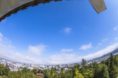 Low angle view of buildings against cloudy sky