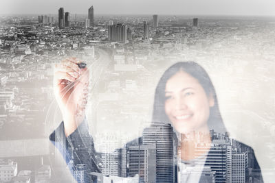 Multiple exposure of woman and buildings in city