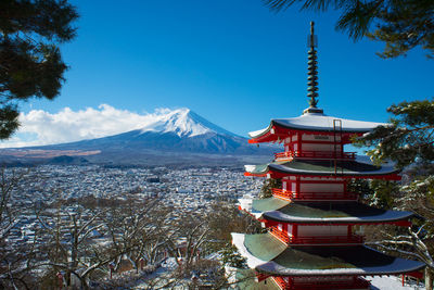 Red pagoda against mt fuji during winter