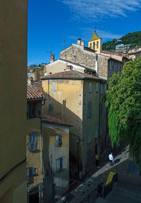 Buildings in town against clear blue sky