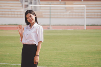 Portrait of woman standing on field