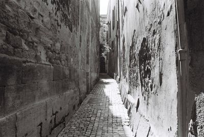 Narrow alley along built structures