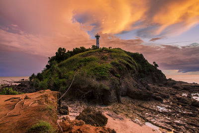 Lighthouse against sky during sunset