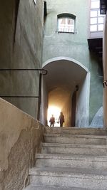 People on staircase in building