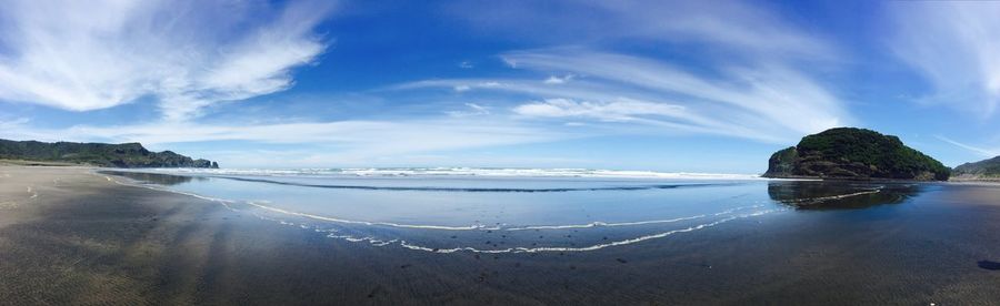 Panoramic view of beach against blue sky
