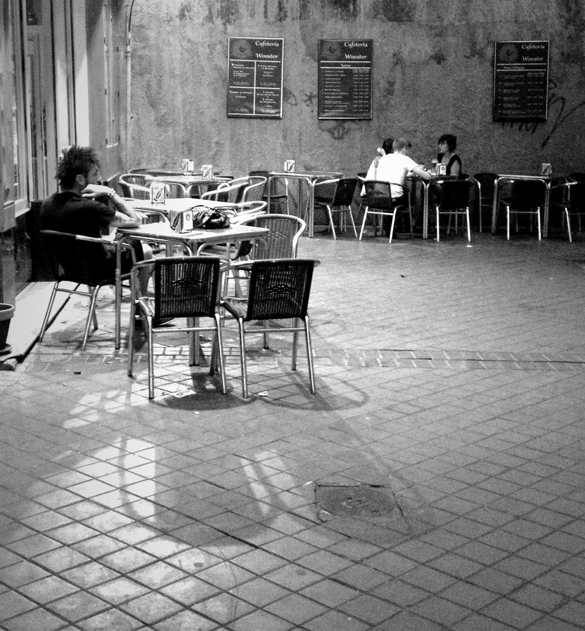 chair, built structure, building exterior, architecture, empty, men, sidewalk cafe, sitting, day, street, cobblestone, seat, full length, sidewalk, bench, relaxation, absence, rear view, outdoors