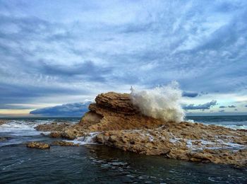 Scenic view of sea against cloudy sky