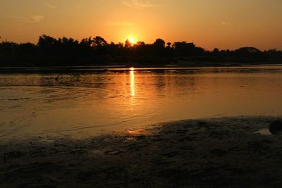 Scenic view of lake against sky during sunset