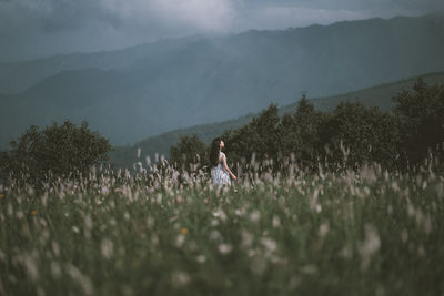 Woman on field against sky