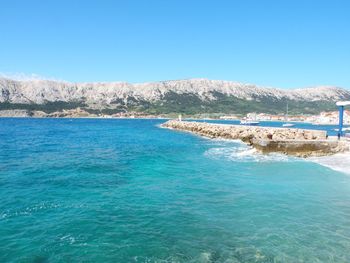 Scenic view of sea against clear blue sky