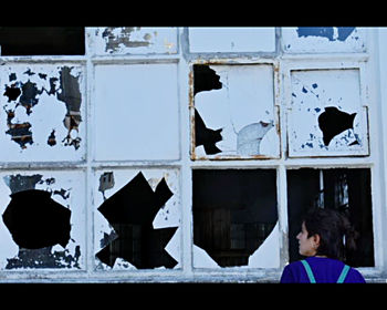 Digital composite image of woman looking through window