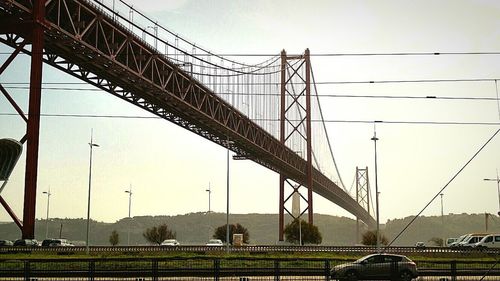 Low angle view of bridge in city against sky