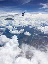 Cropped image of airplane flying over mountains