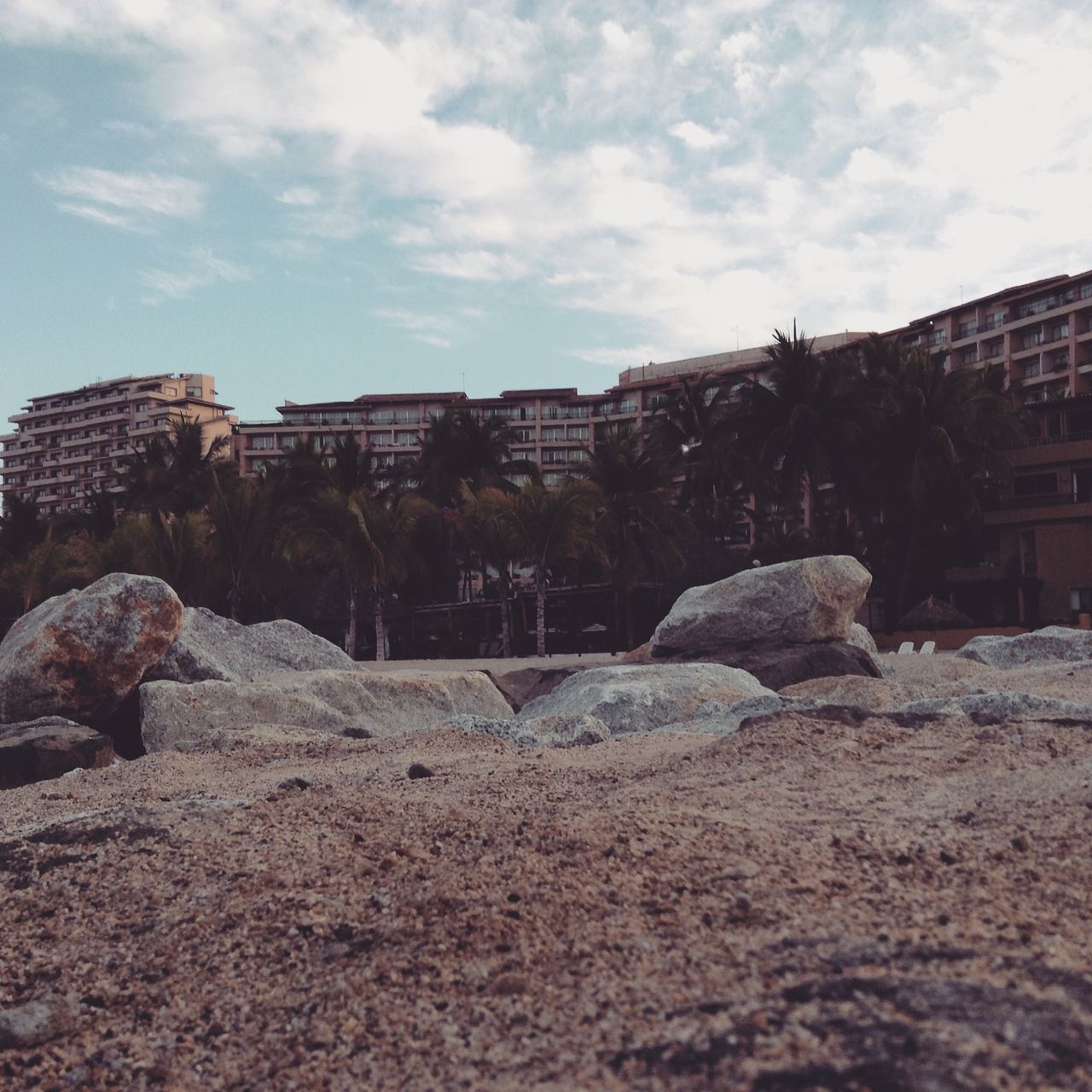 architecture, building exterior, built structure, sky, house, cloud - sky, residential structure, cloud, rock - object, residential building, day, tree, abandoned, outdoors, sunlight, old, no people, damaged, building, stone - object