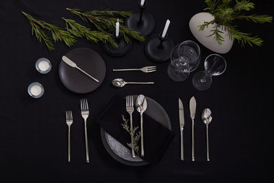 High angle view of glasses on table against black background