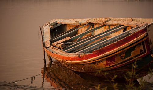 Old boat moored in river