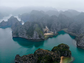 Scenic view of sea and mountains against sky