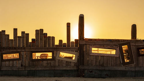 Buildings in city against clear sky during sunset