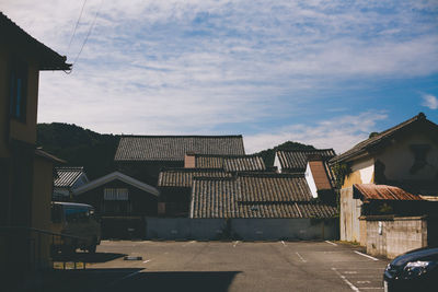 Residential buildings against cloudy sky