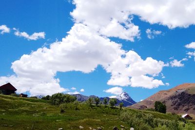 Low angle view of green landscape against sky