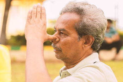 Close-up portrait of man looking away outdoors