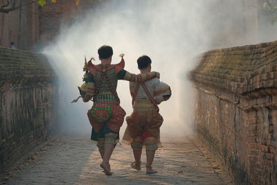 Rear view of couple walking outdoors