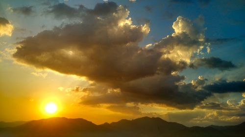 Scenic view of silhouette mountains against sky during sunset