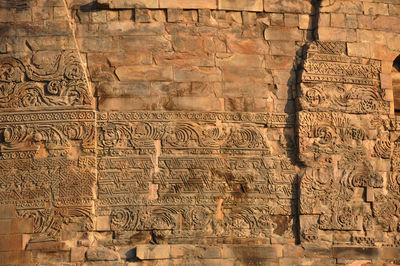 View of sculptures on brick wall