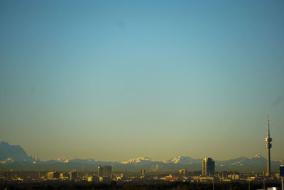 Buildings in city at sunset