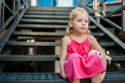 Young woman sitting on staircase