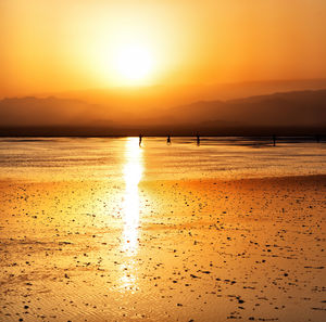 Scenic view of beach against sky during sunset