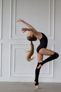 Young gymnast girl stretching and training