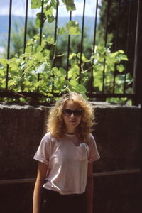 Portrait of woman standing against wall