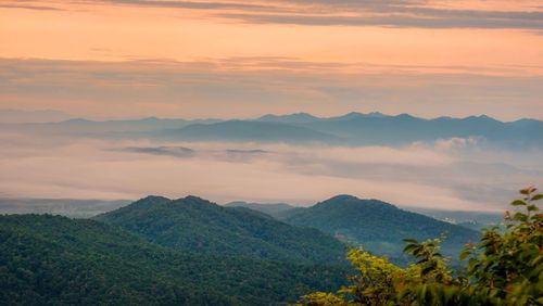 Scenic view of mountains against sky at sunset