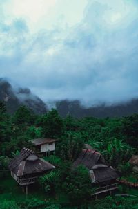 Houses on mountain against sky