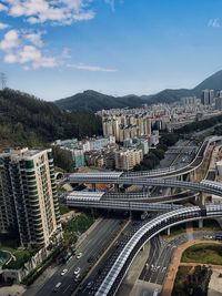 High angle view of street amidst buildings against sky