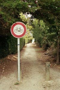 Road sign by trees