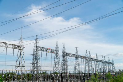 Low angle view of electricity pylon against sky