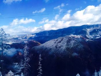 Scenic view of mountains against cloudy sky