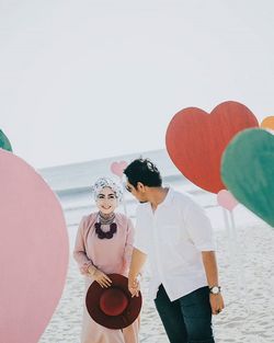 Couple standing with umbrellas