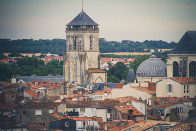 High angle view of clock tower in town against sky