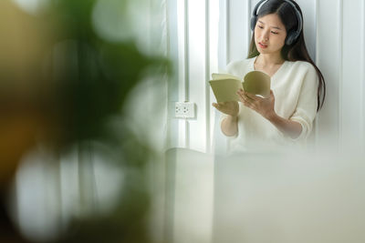 Young woman drinking coffee cup at home