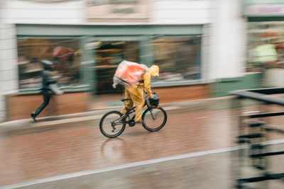 Bicycle parked on wall in city