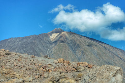 Scenic view of volcanic mountain against blue sky tenerife