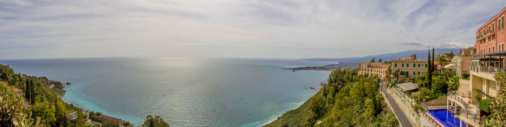 Panoramic view of sea and buildings against sky